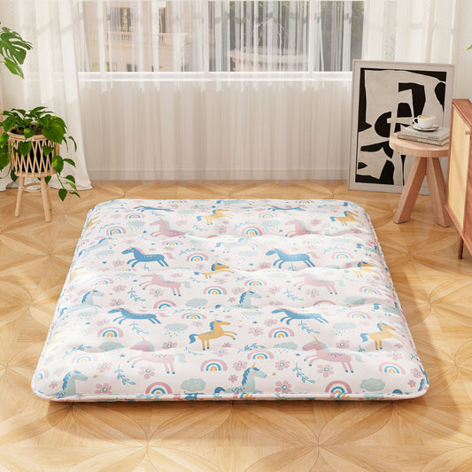 The bedding laid out on a wooden floor in a bright living room setting