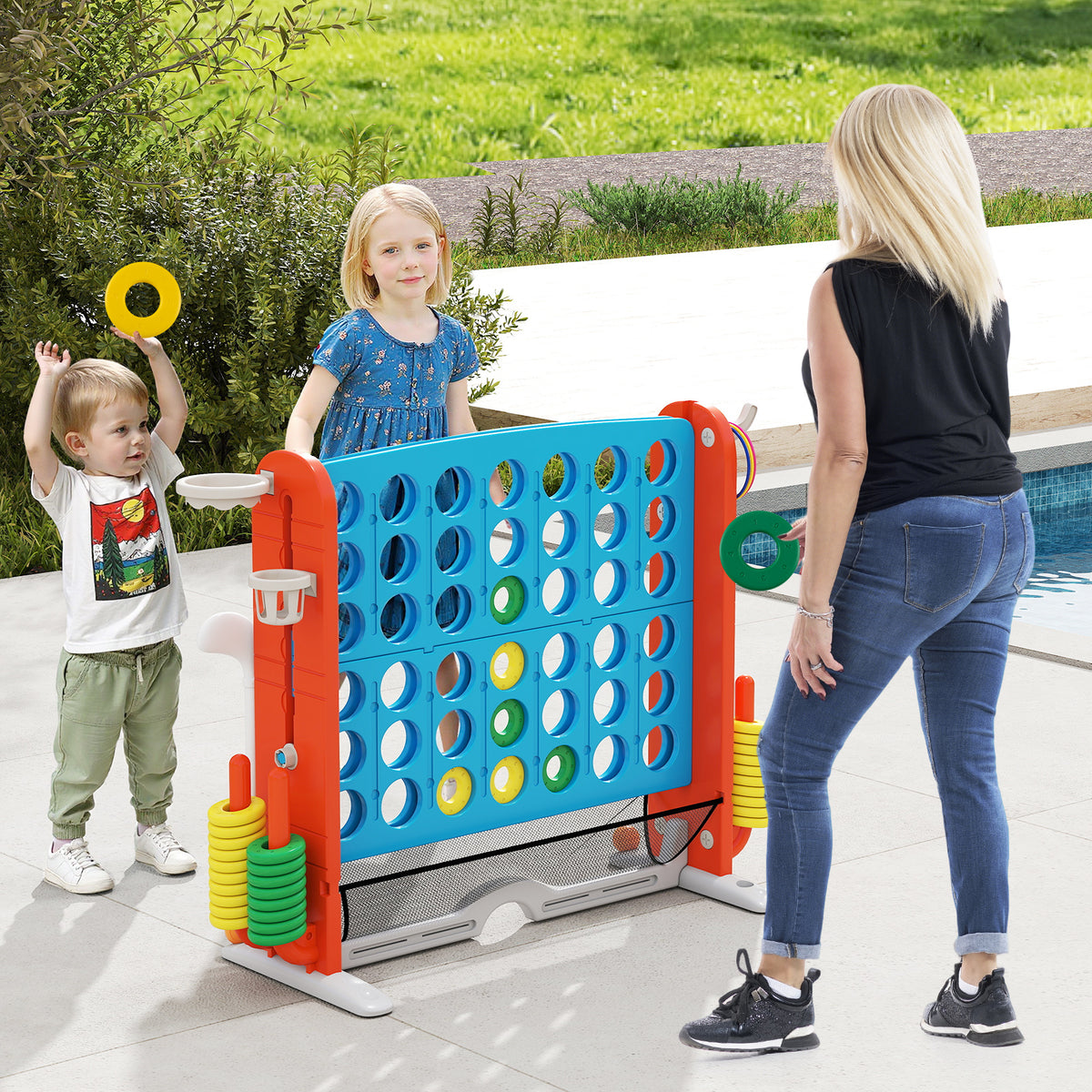 Family playing the lawn game outside by a swimming pool with rings
