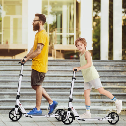 A man and a boy ride white kick scooters with adjustable handlebars outdoors