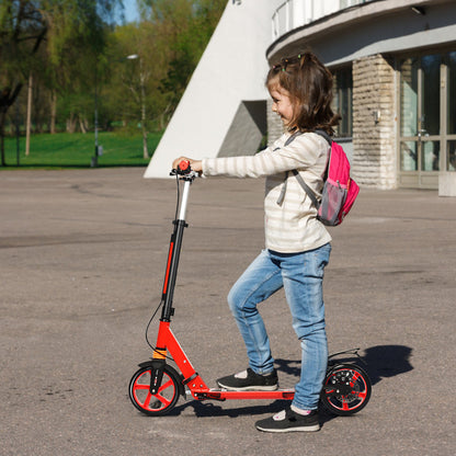 A girl with a backpack rides the red kick scooter on a paved path