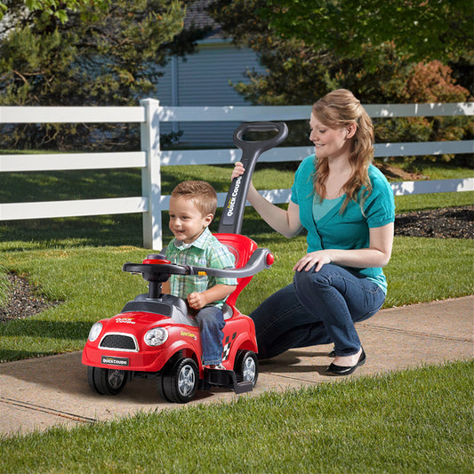 The push and pedal ride on toy being pushed by a woman with a young child sitting inside
