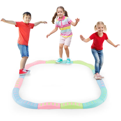 Three children balancing on the colourful toy sports beams arranged in a square shape