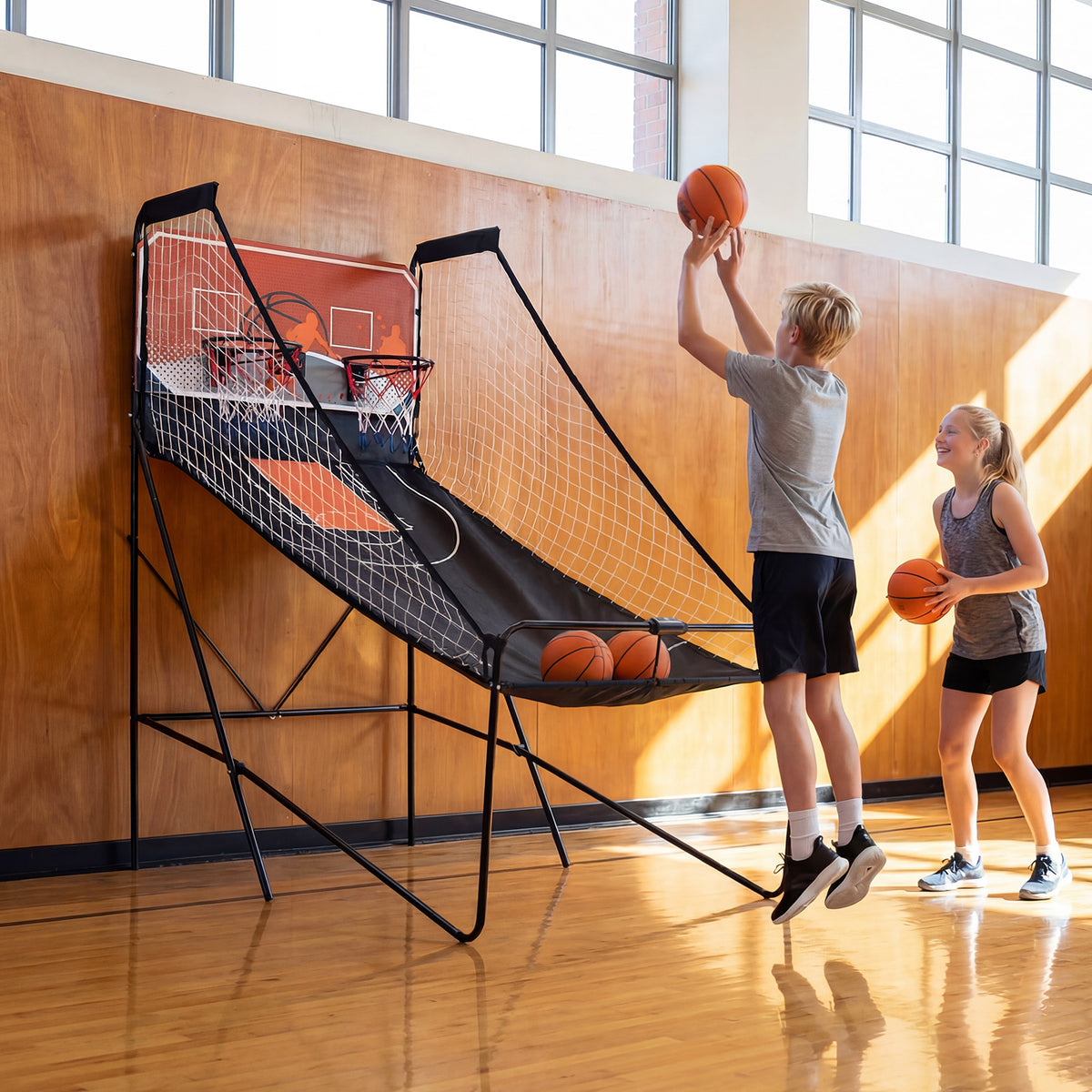 Two children playing the game room basketball hoop machine in a room