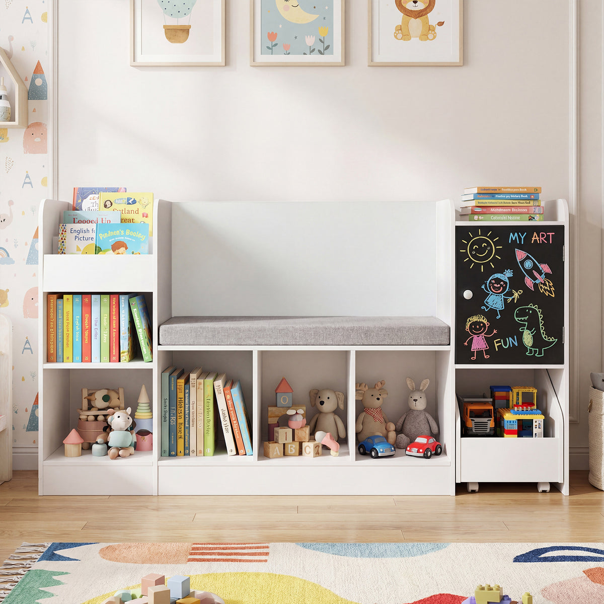 The white kids storage unit is filled with books and toys on a colourful rug