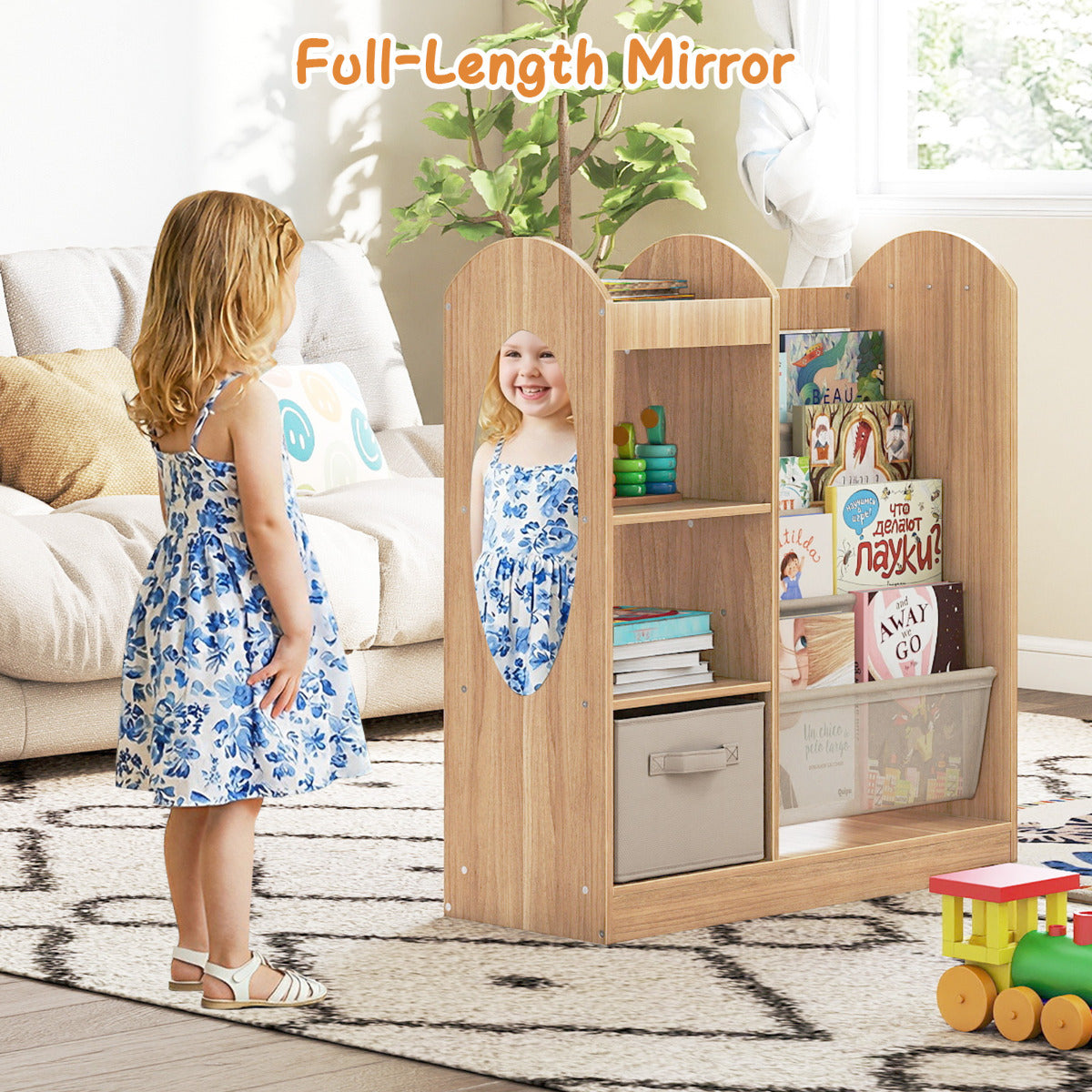 A child looking into the full-length mirror on the side of the kids bookshelf