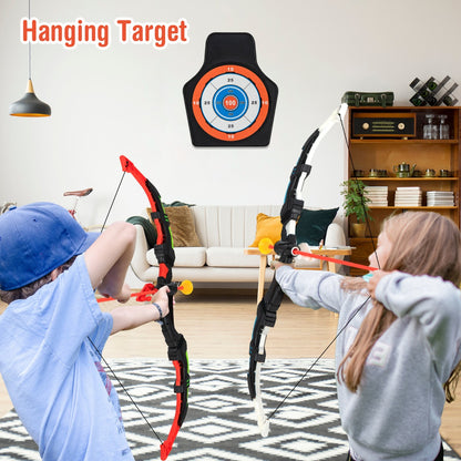 Kids Bow and Arrow Set, two children aiming the archery set at a hanging target in a living room