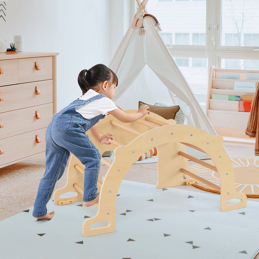 A young child climbing on the wooden climbing arch sensory table