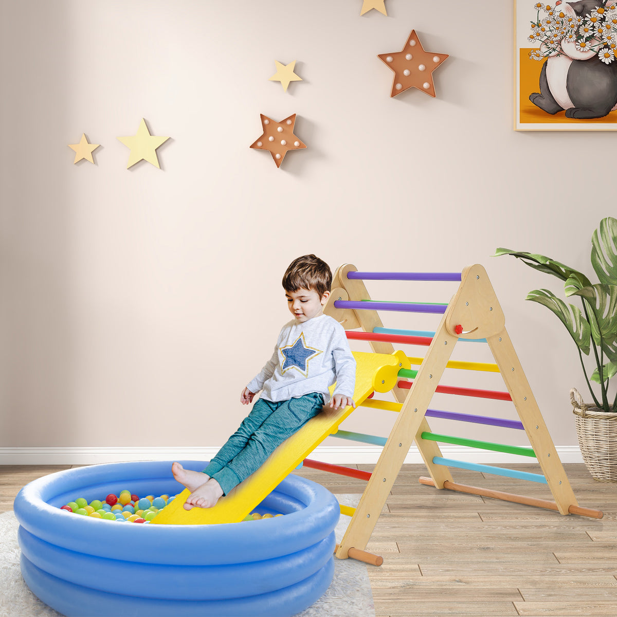 The wooden climbing frame with a slide is placed next to a paddling pool