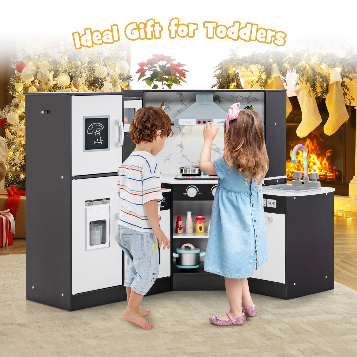 Two children playing with the corner kitchen set in a festive Christmas room