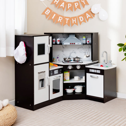 The play kitchen set placed in a corner of a room with birthday decorations
