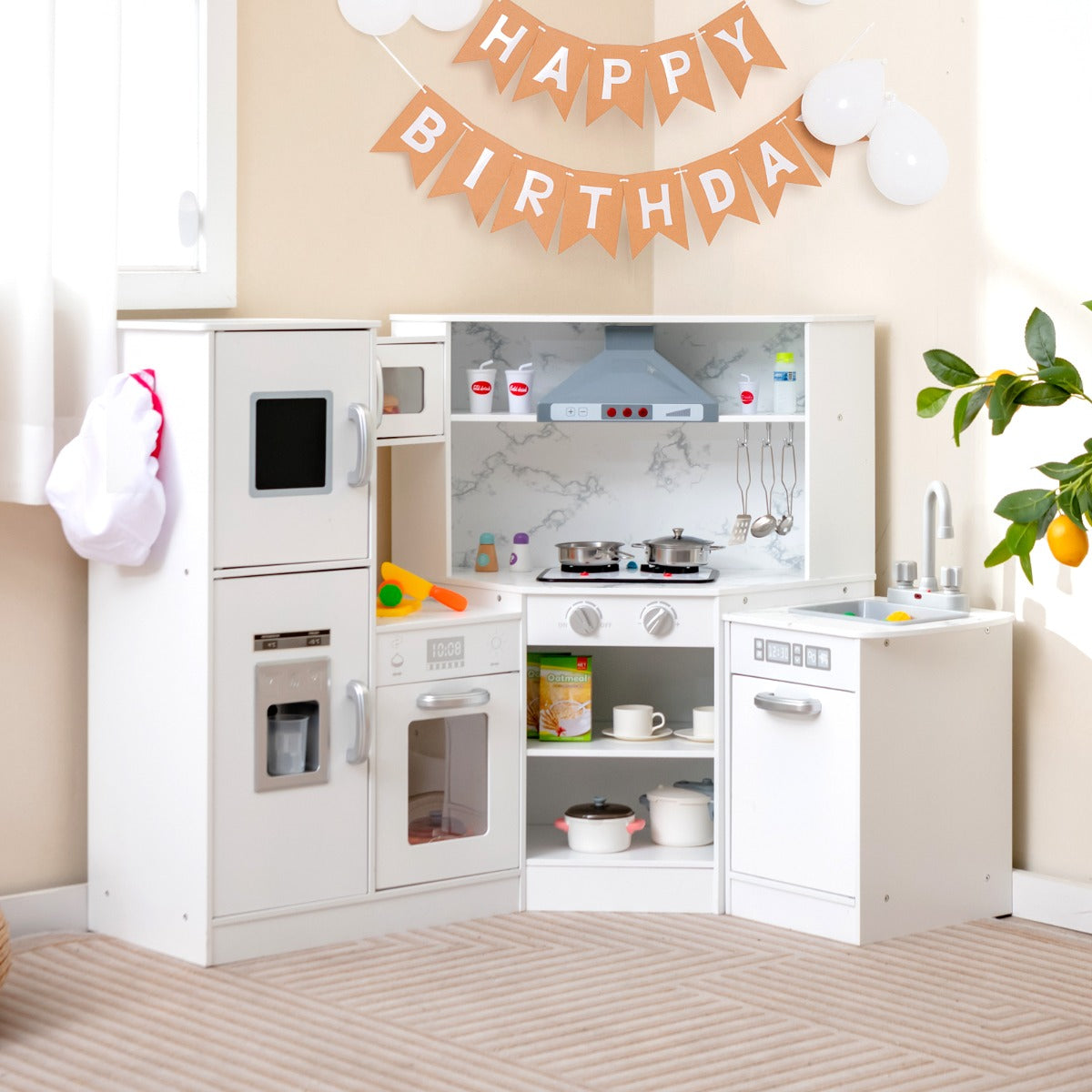 The white corner play kitchen set with a washing basin, shown in a room with birthday decorations