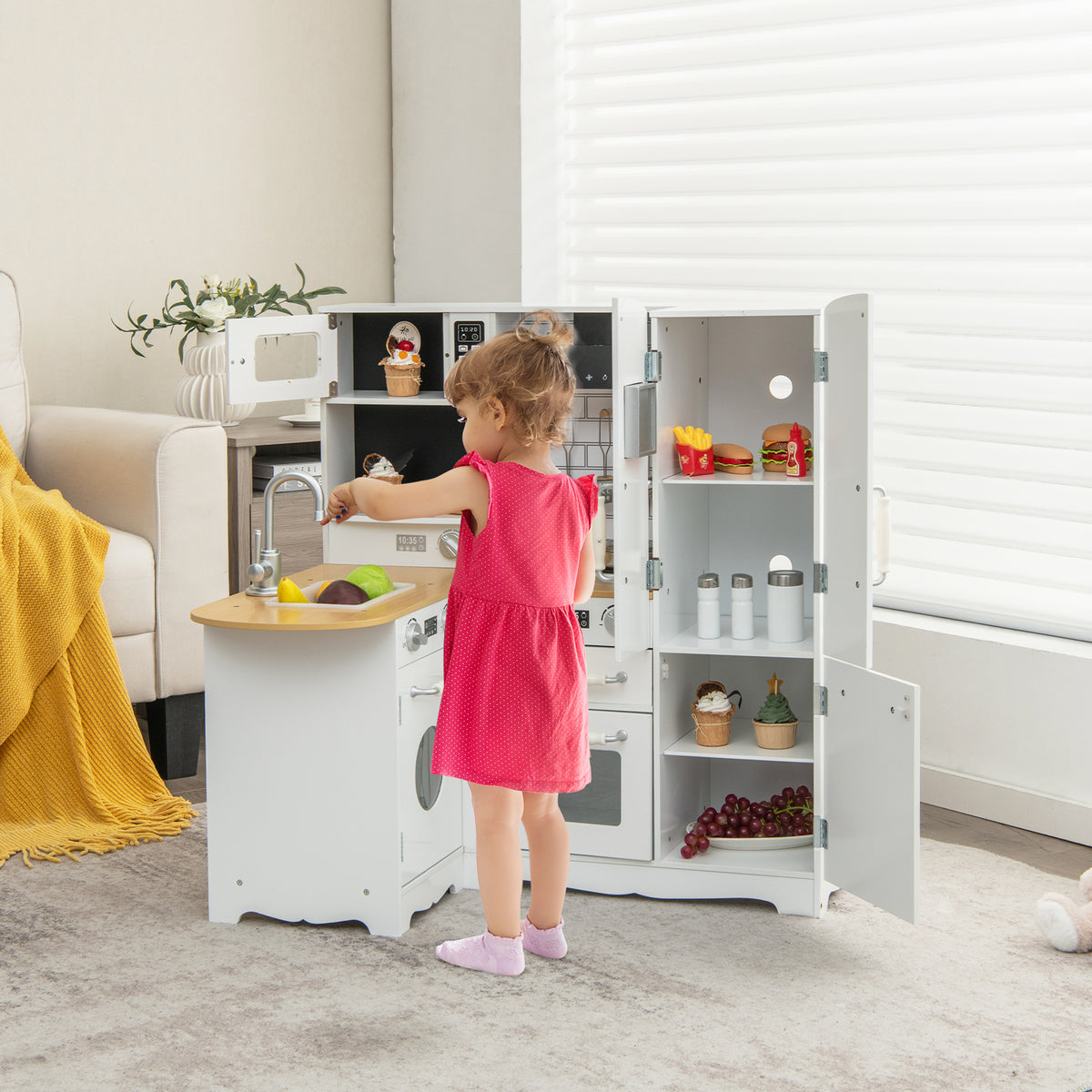 A young girl plays with the wooden play kitchen in a living room setting