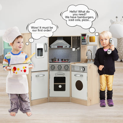 Two children playing with the wooden kitchen playset, one holding a pot and the other on the phone