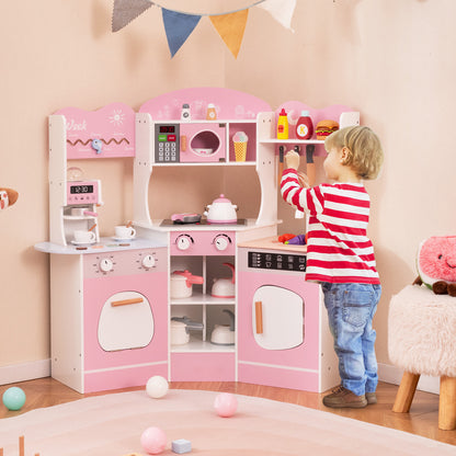 A boy playing with the pink wooden play kitchen set, pretending to cook