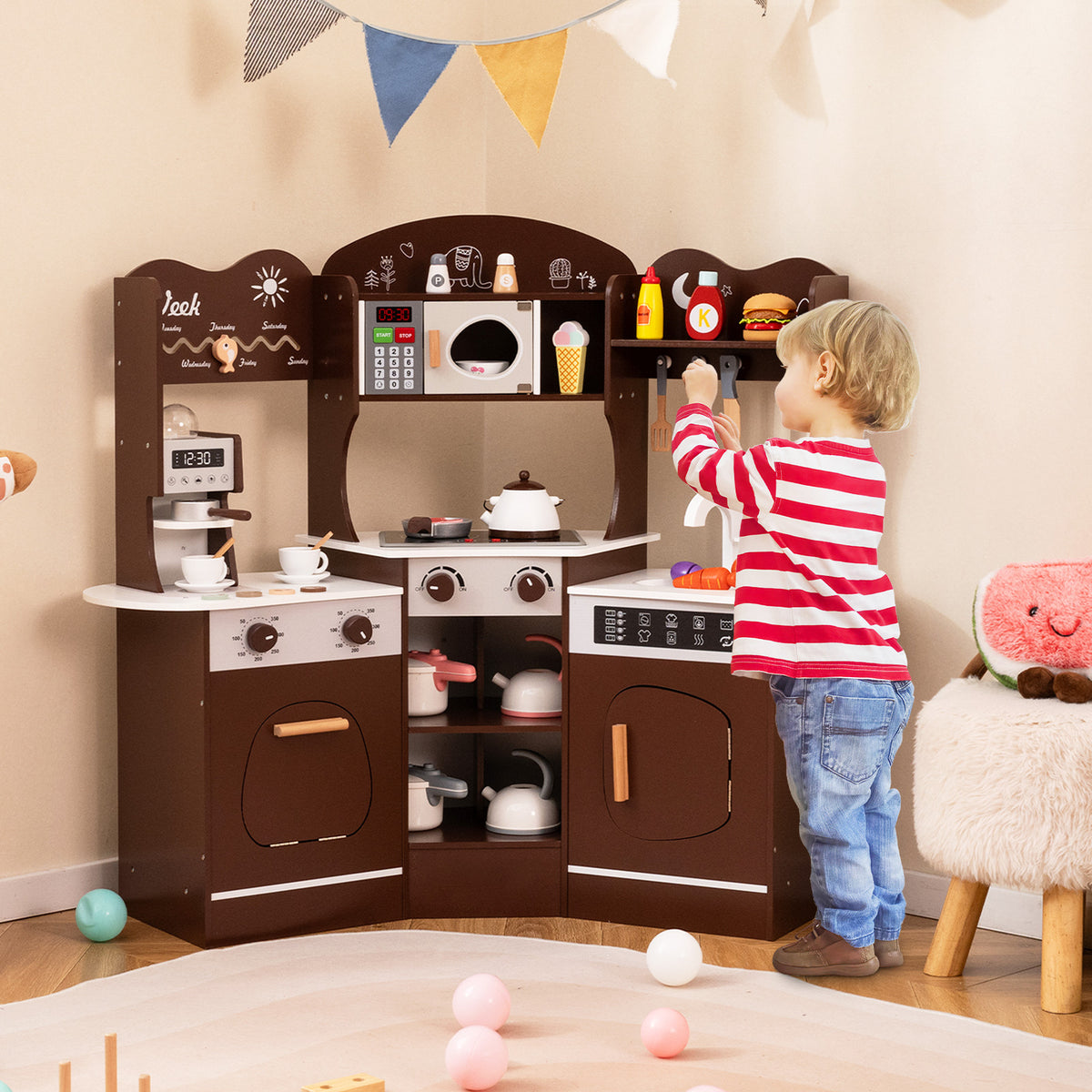 A child using the wooden play kitchen with microwave and sink