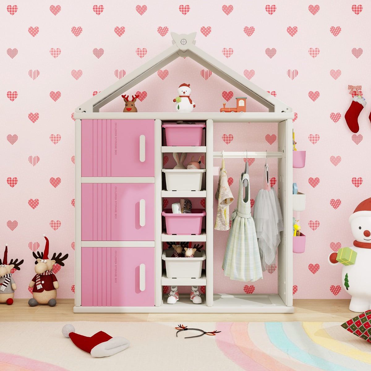 The kids storage unit filled with clothes and toys in a room with heart patterned wallpaper