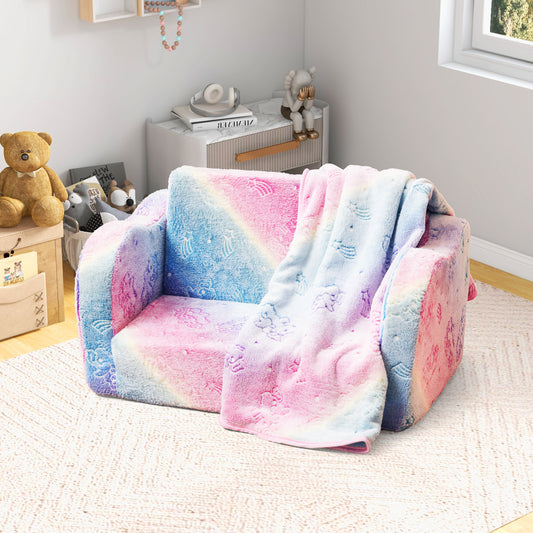 The pink toddler sofa with a matching blanket draped over the arm in a bright bedroom