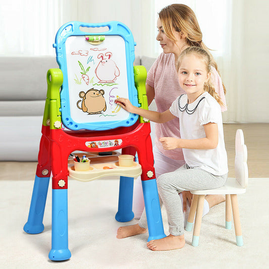 A child draws on the magnetic side of the art easel with a woman standing behind