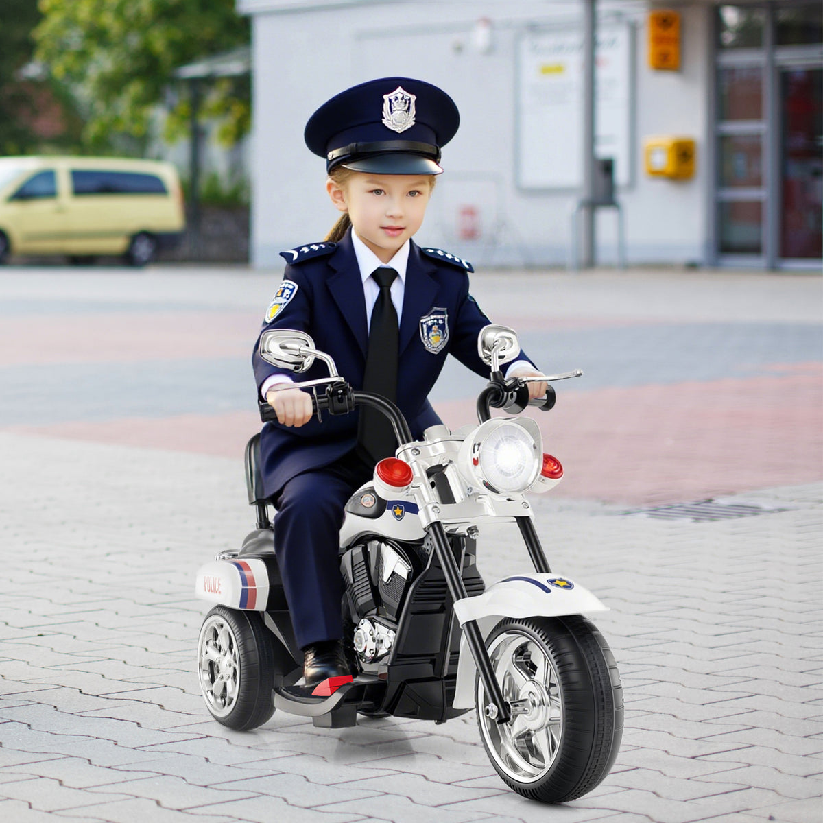 The kids electric motorbike shown from the front with a child in police uniform sitting on it