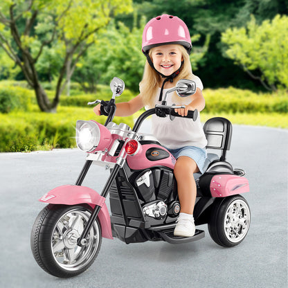 A young girl wearing a pink helmet riding the pink kids electric motorbike on a paved path