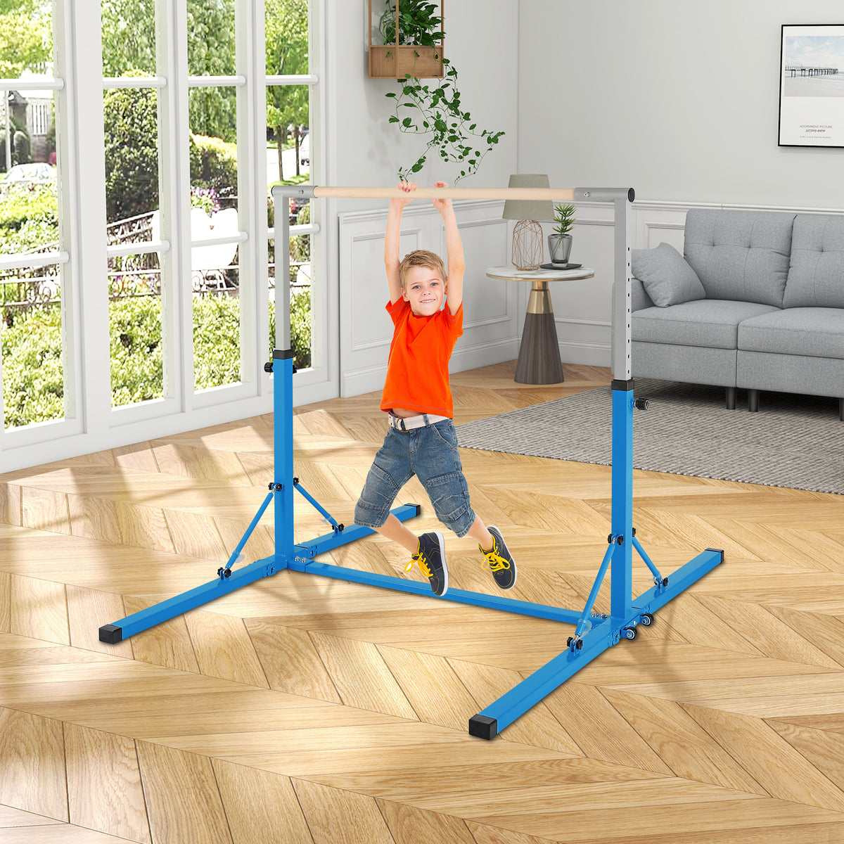A young boy swinging on the blue kids gymnastics bar in a living room