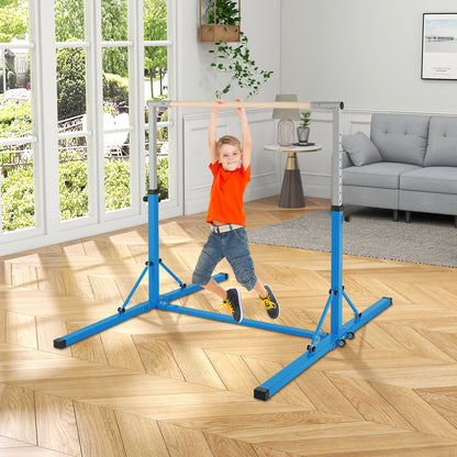 A young boy swinging on the blue kids gymnastics bar in a living room