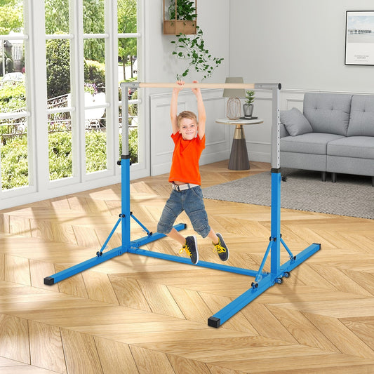 A young boy swinging on the blue kids gymnastics bar in a living room