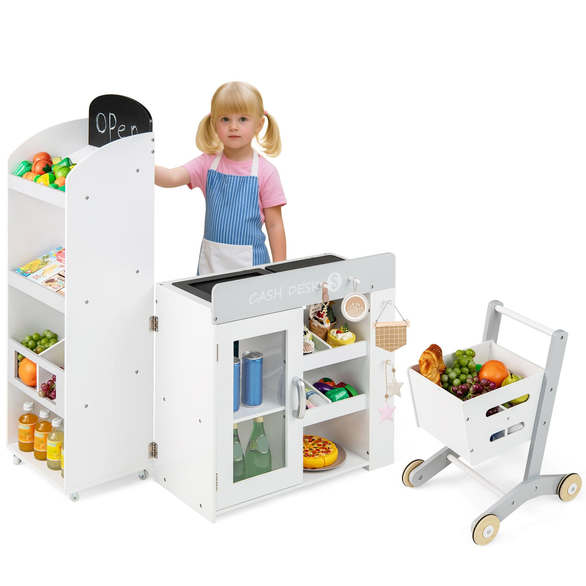 Young girl standing by the play kitchen set with shopping cart