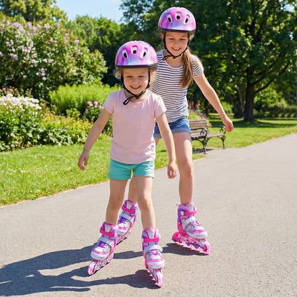 Two young girls wearing pink protective gear and pink inline skates, skating together on a path in a park