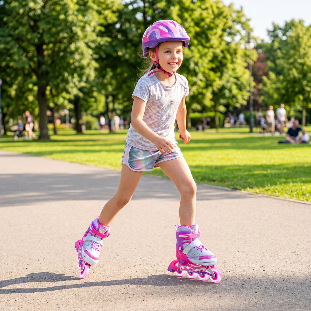 A young girl wearing pink inline skates and helmet, smiling as she skates in a park