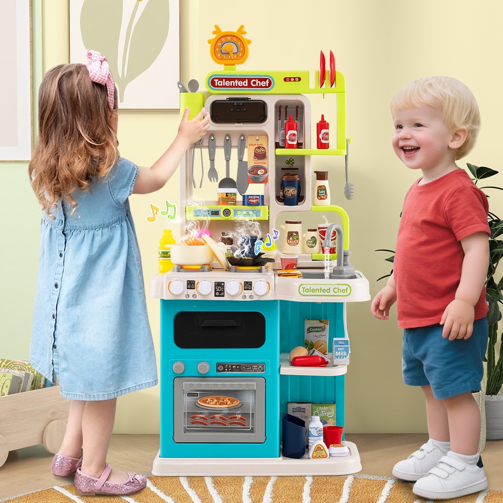 Two children playing with the blue play kitchen set, one is reaching for the sink