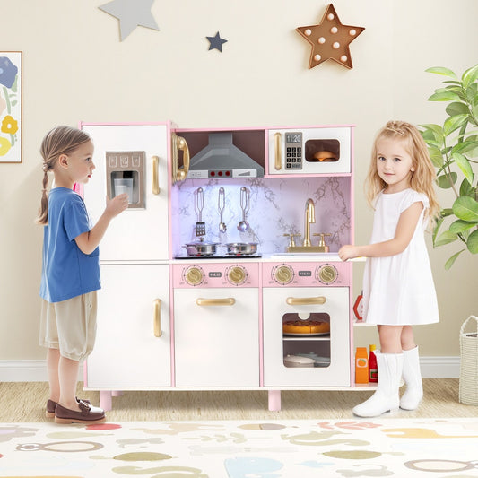 Two children playing with the pink wooden play kitchen set in a room