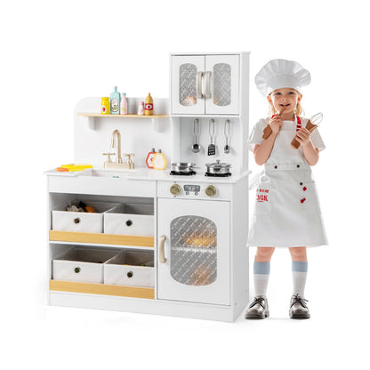Kids Kitchen Playset Toy with a child dressed as a chef standing next to the white unit