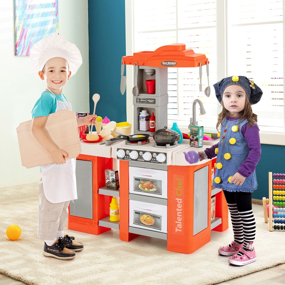 Two children playing with the orange play kitchen set with accessories