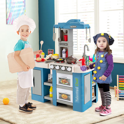 The play kitchen set being used by two children dressed as chefs in a bright room