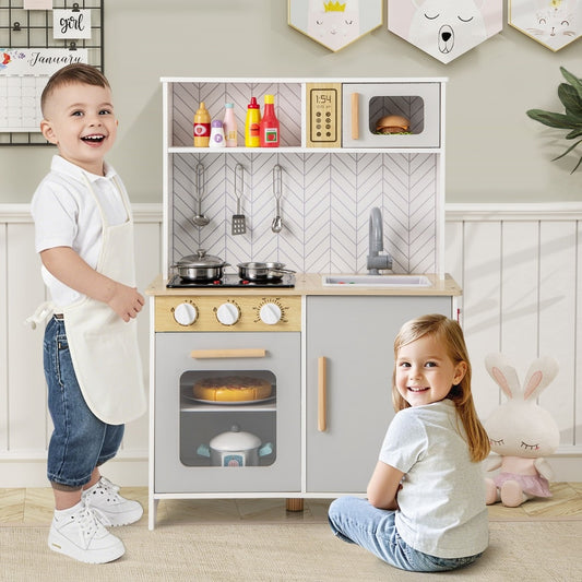 Children playing with the white kitchen playset in a room