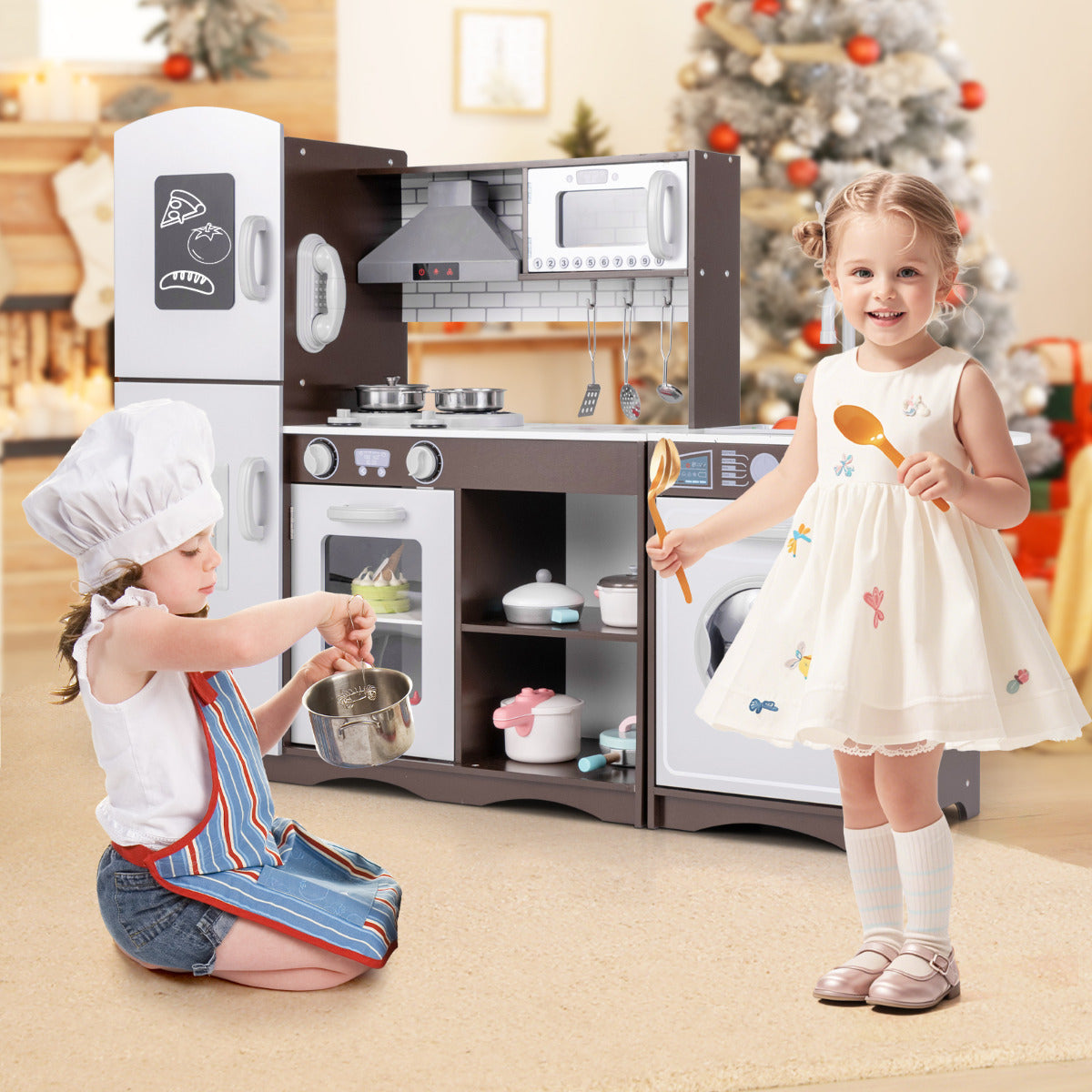 Two children playing with the wooden kitchen set, one with a pot and the other holding a spoon