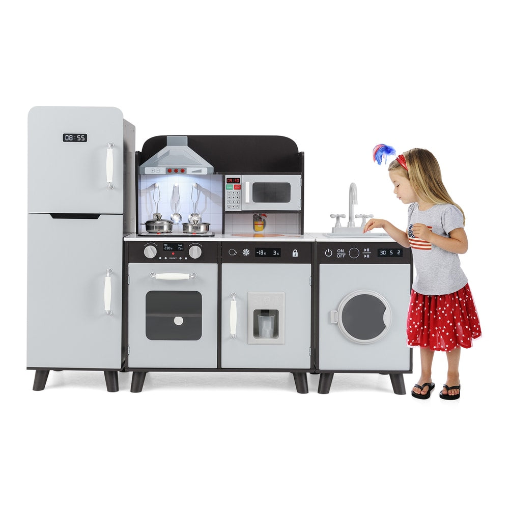 A young girl wearing a red spotted dress and a patriotic headband plays with the brown wooden play kitchen set
