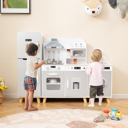 Two children playing with the grey kitchen playset with refrigerator and washing machine
