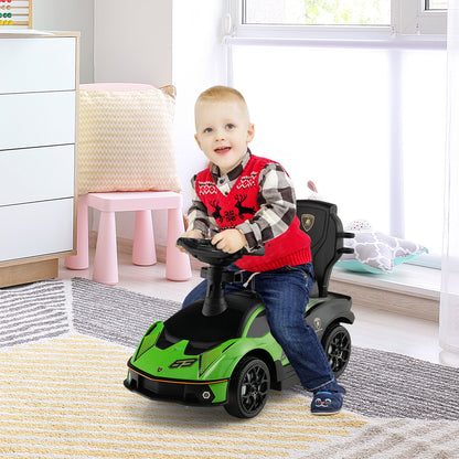 A young boy sits in the green ride on car, steering it