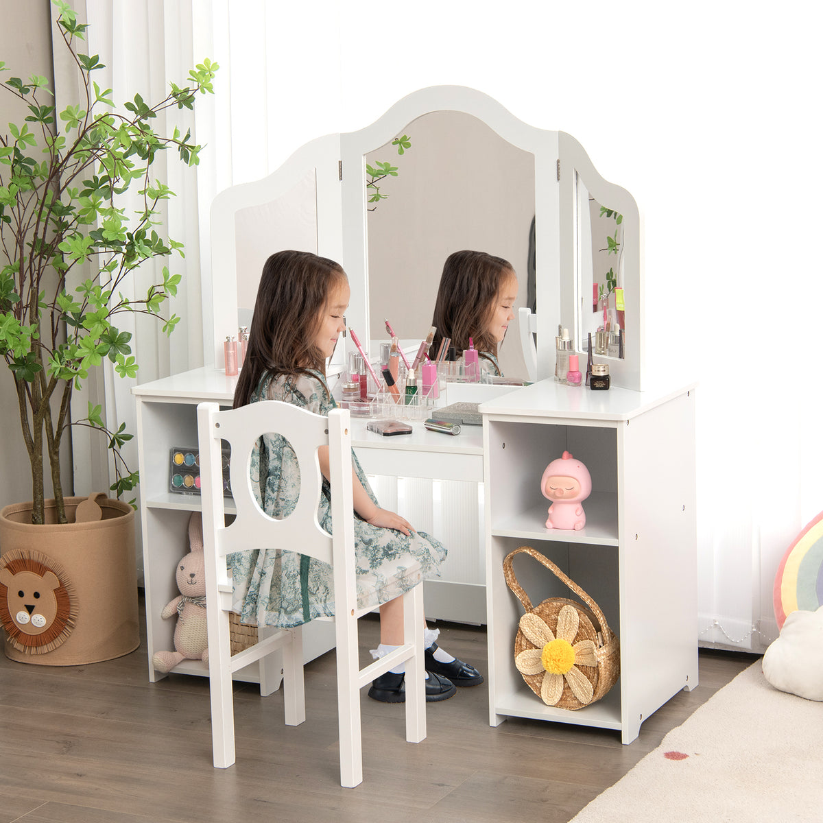 A young girl sits at the kids vanity table applying makeup