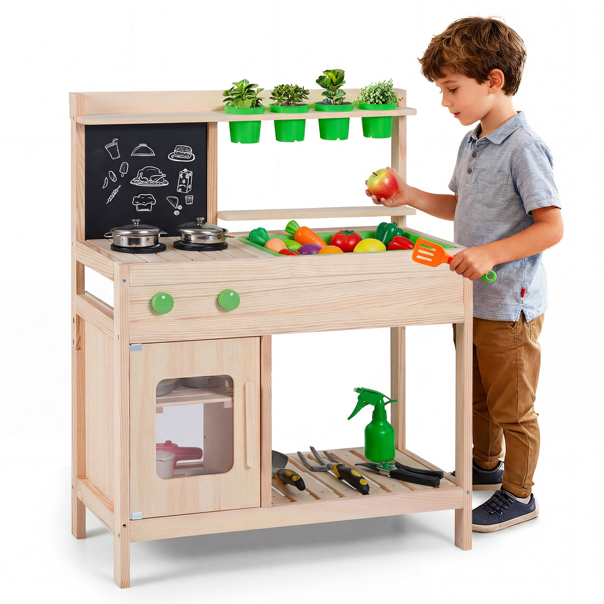 A boy playing with toy fruit and vegetables at the wooden play kitchen set