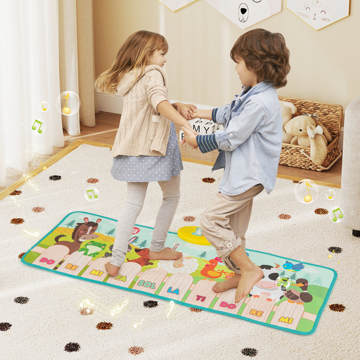 The musical floor mat with two children dancing together on the colourful piano keys