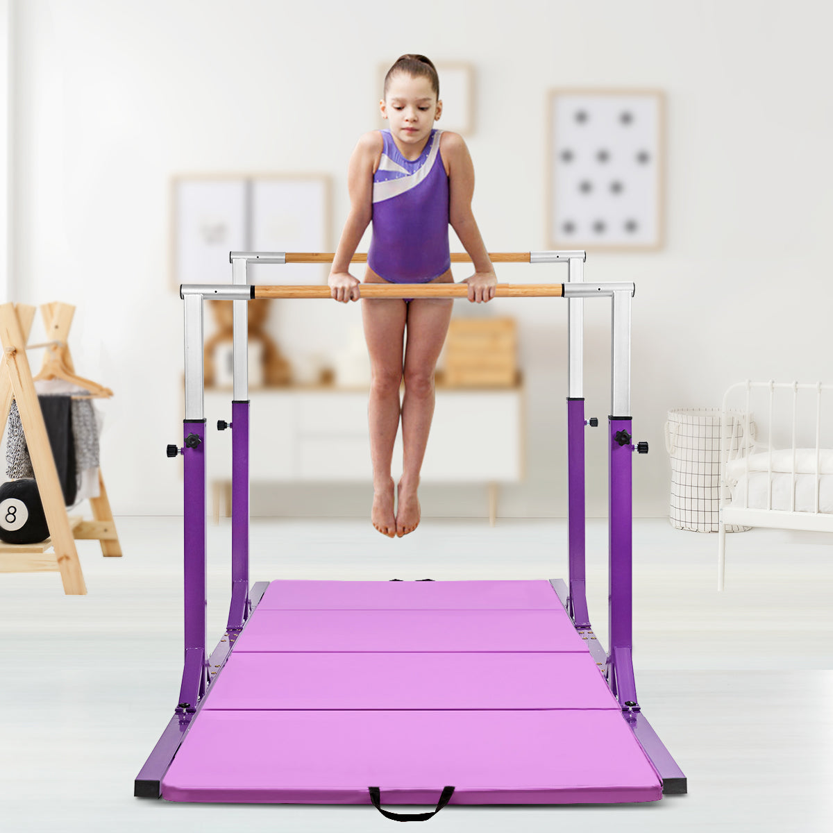 Young girl training on the purple kids parallel gymnastics bar with mat