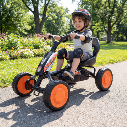 A young boy wearing a helmet and pads riding the push and pedal ride on toy