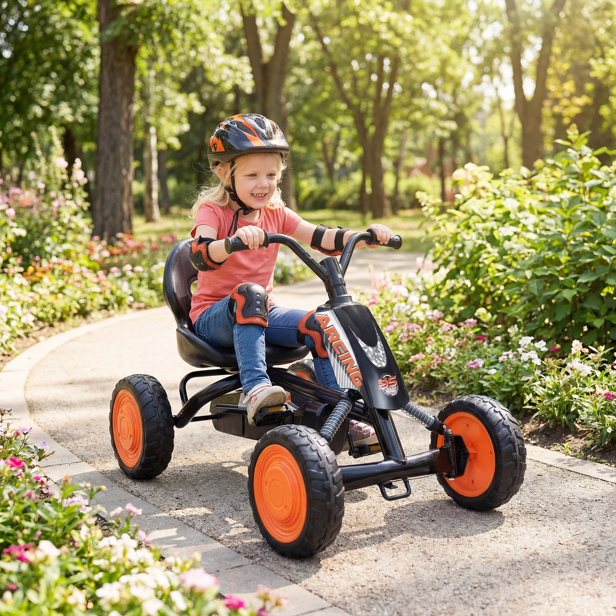 The push and pedal ride on toy being ridden by a child on a paved path in a park