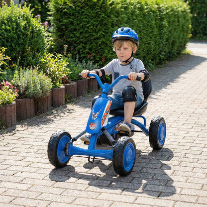 The pedal ride on toy being driven by a young boy on a paved path next to a green hedge