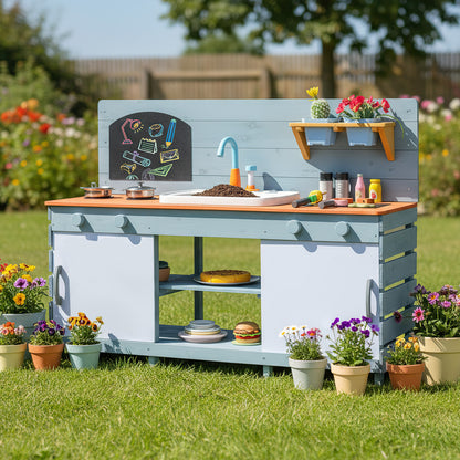 The play kitchen set placed on a green lawn surrounded by colourful flowers