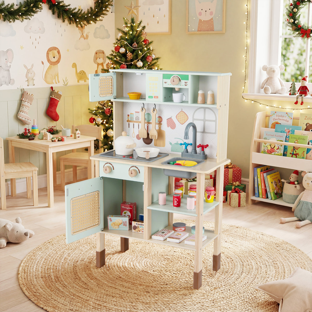 The green play kitchen set is shown in a festive room with a Christmas tree and presents
