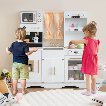Children playing with the wooden play kitchen set, one child at the stove and another at the sink